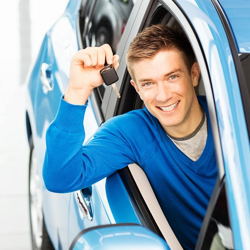 Young man holding a car key