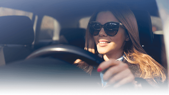 Woman wearing sunglasses driving
