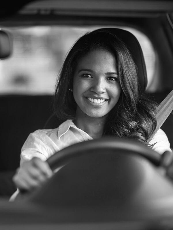 Smiling woman driving a car