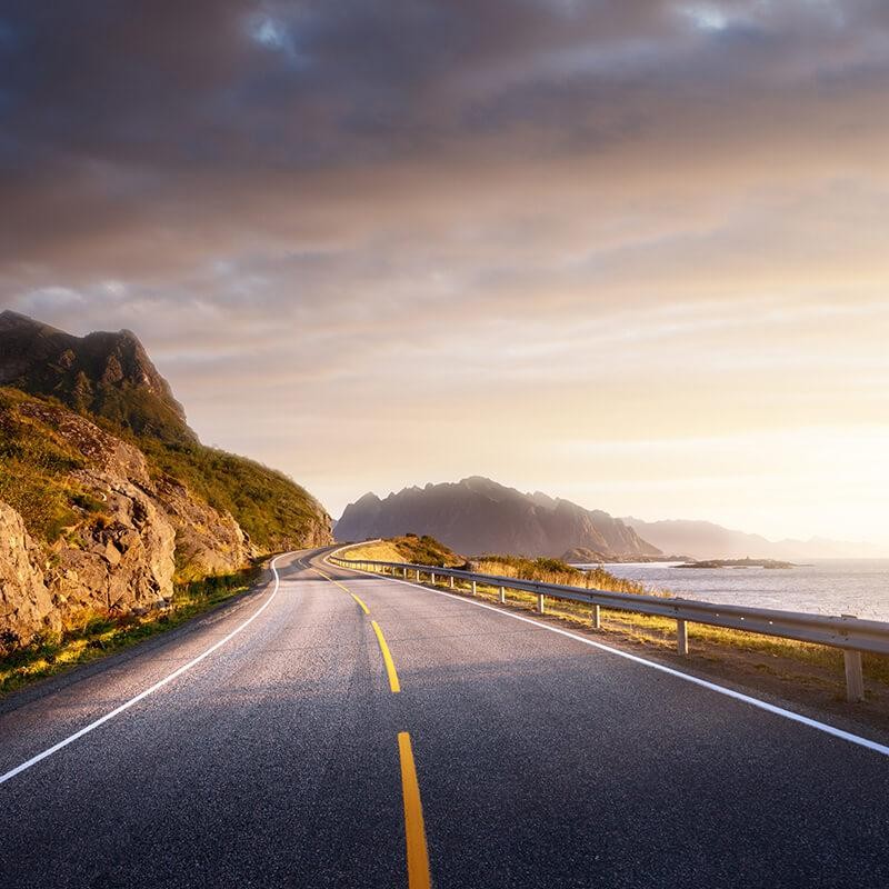 Sunlit road by the water