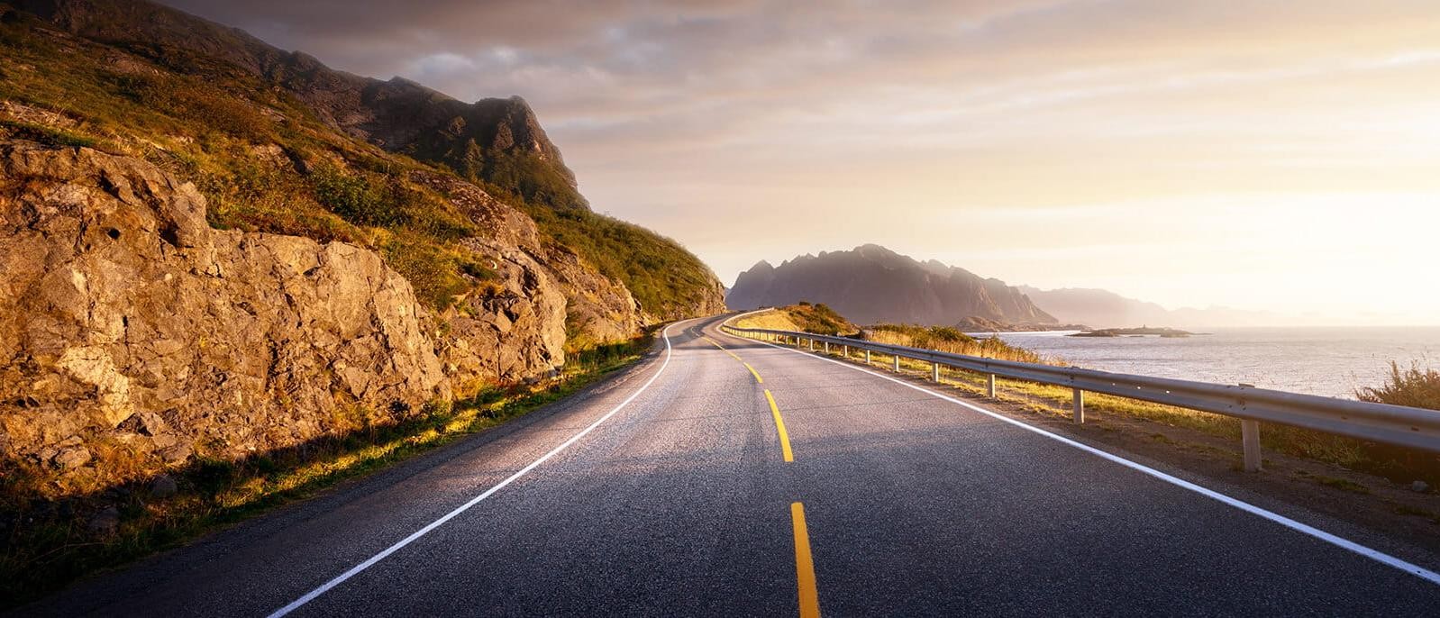 Sunlit road by the water