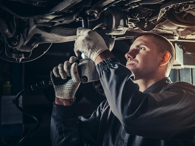 Service mechanic working on a vehicle