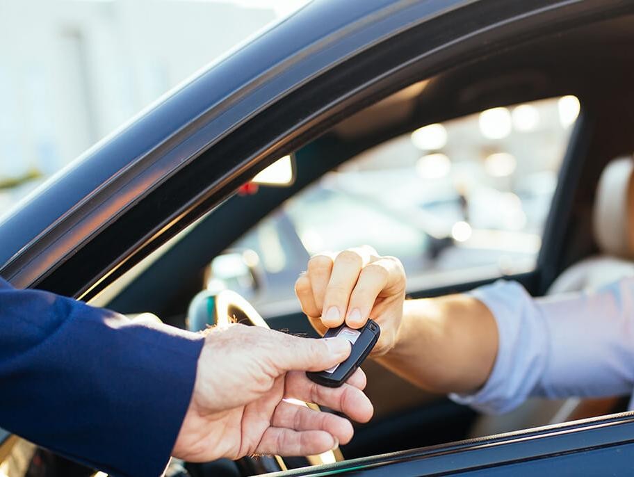 Man taking the keys to his new car