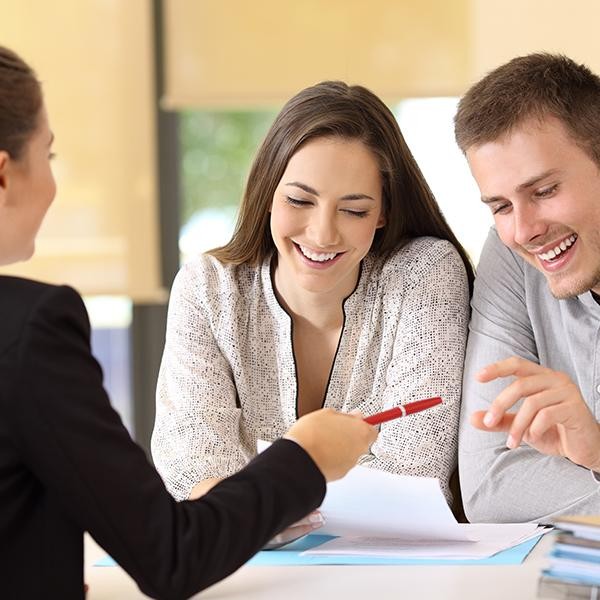 Couple signing finance documents