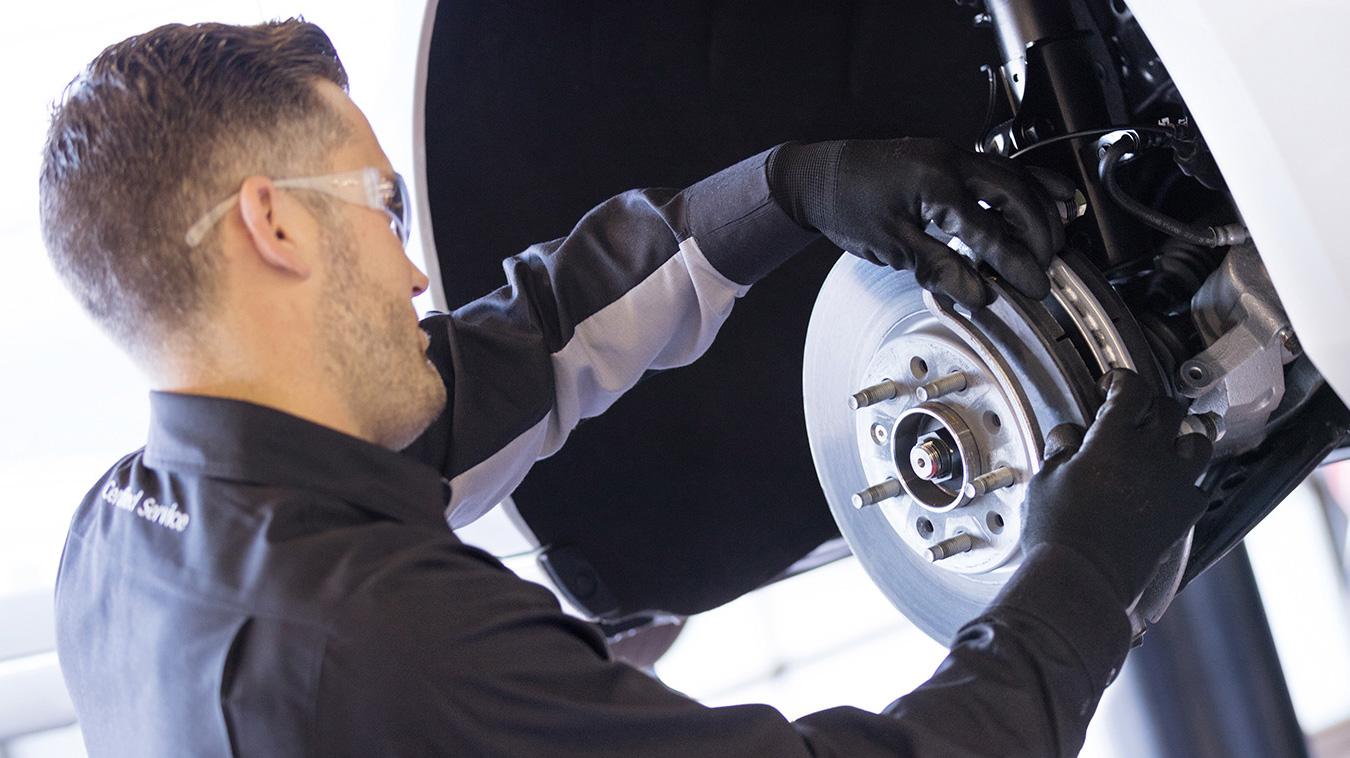 Service technician changing brake pads