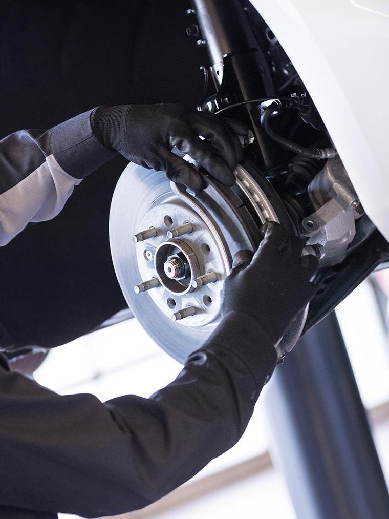 Service technician changing brake pads