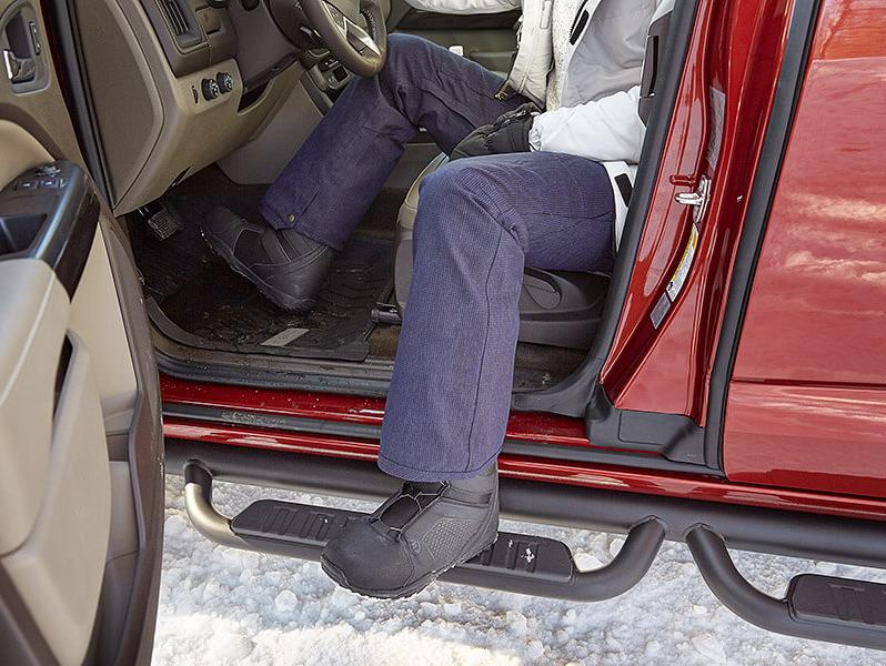 Woman getting out of truck, using rocker-step accessory