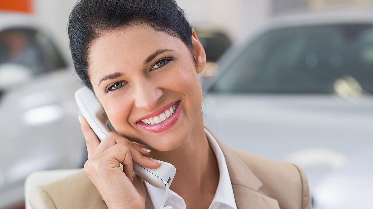 Smiling Women at dealership on phone