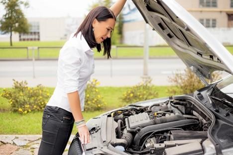 Woman experiencing engine problems hears a strange engine sound.