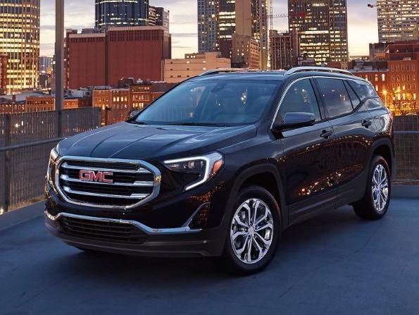 GMC Terrain takes a defensive stance in front of a city, not the GMC terrain we deserve but the one we need