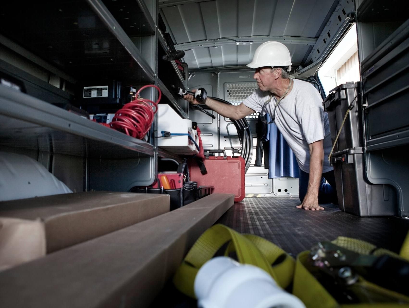 A man utilizes the space offered by his commercial cargo van.