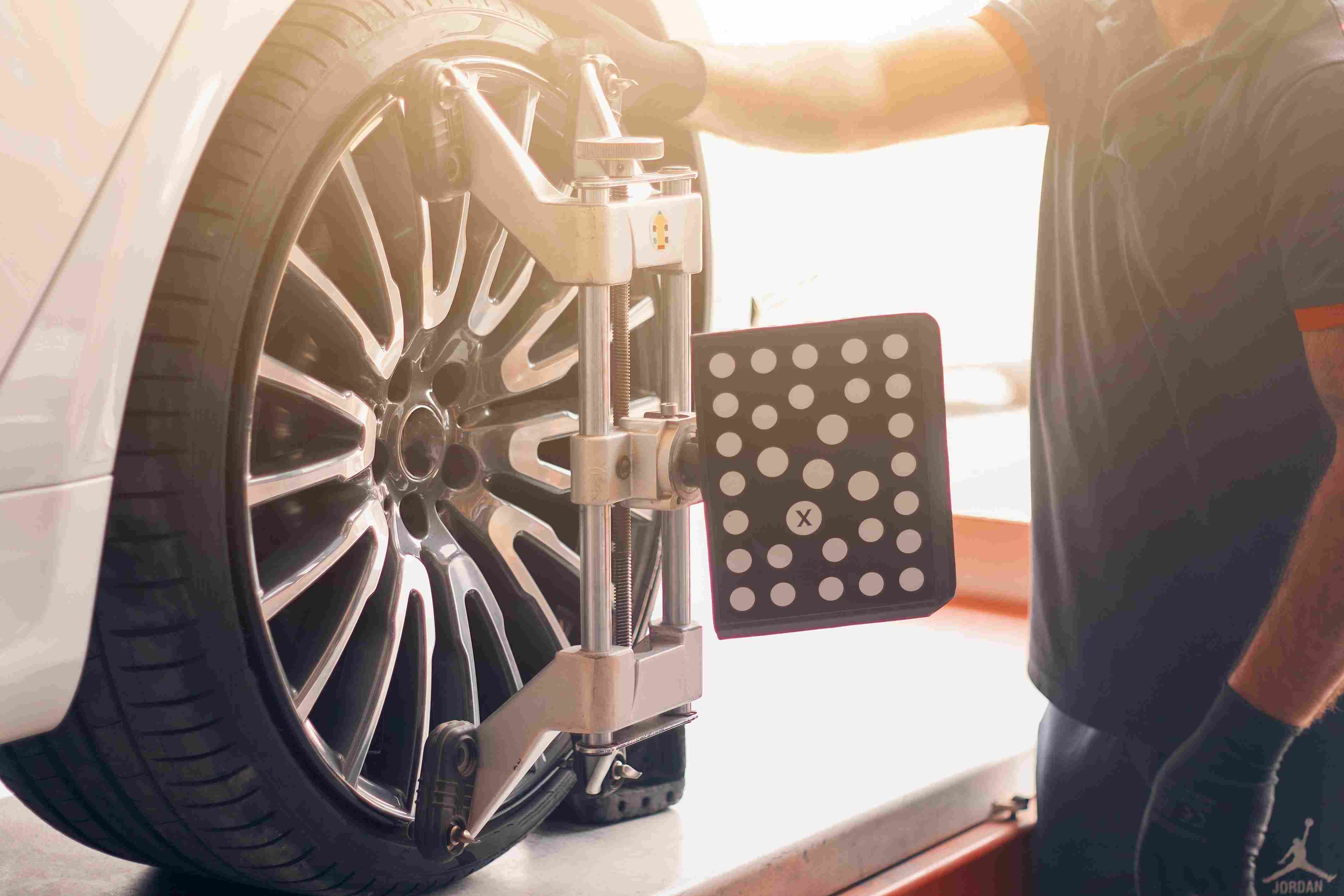 mechanic performing a Wheel Alignment