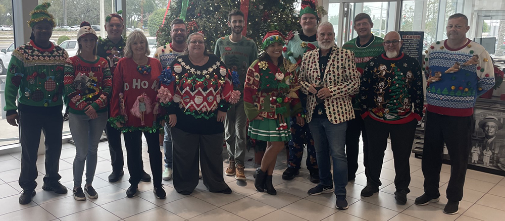 Ferman Chevrolet of Tarpon Springs Employees smile for Ugly Christmas Sweater contest