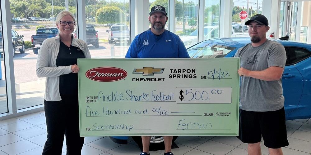Anclote Sharks Football receiving sponsorship donation from Ferman Chevrolet of Tarpon Springs