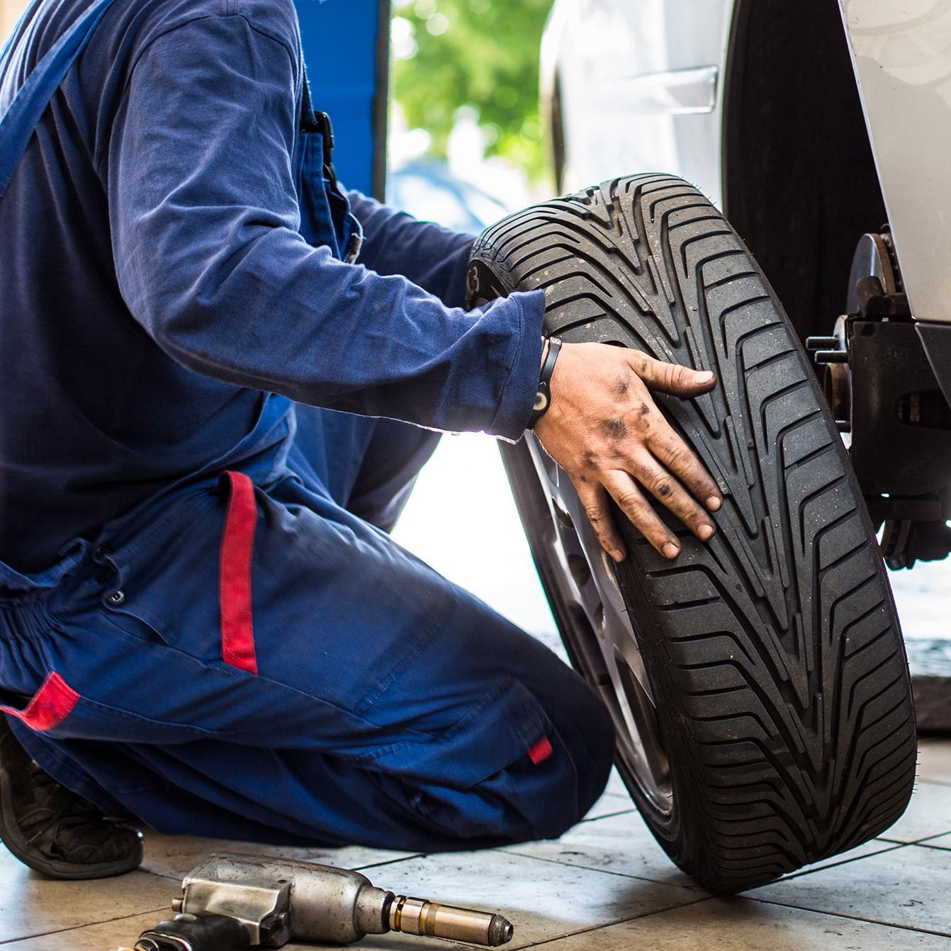 Mechanic checking the pressure on a tire