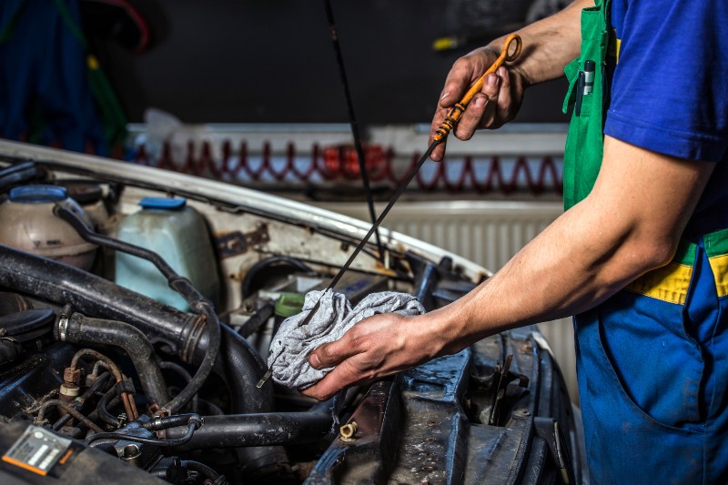 Mechanic checking an engine's oil