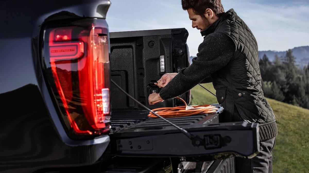 A man servicing Sierra 3500 HD cc Car