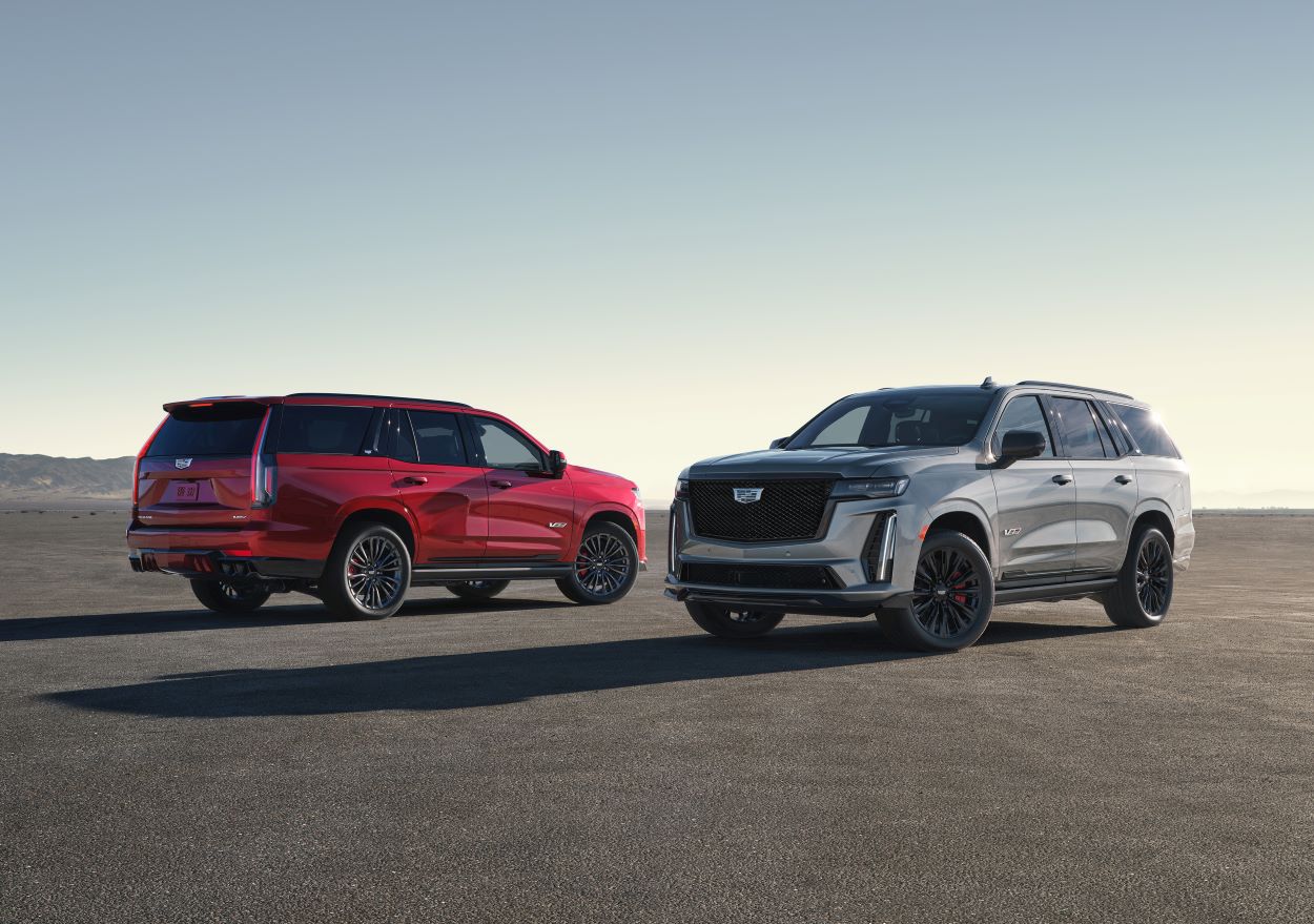 A pair of Cadillac Escalade-V SUVs are parked.