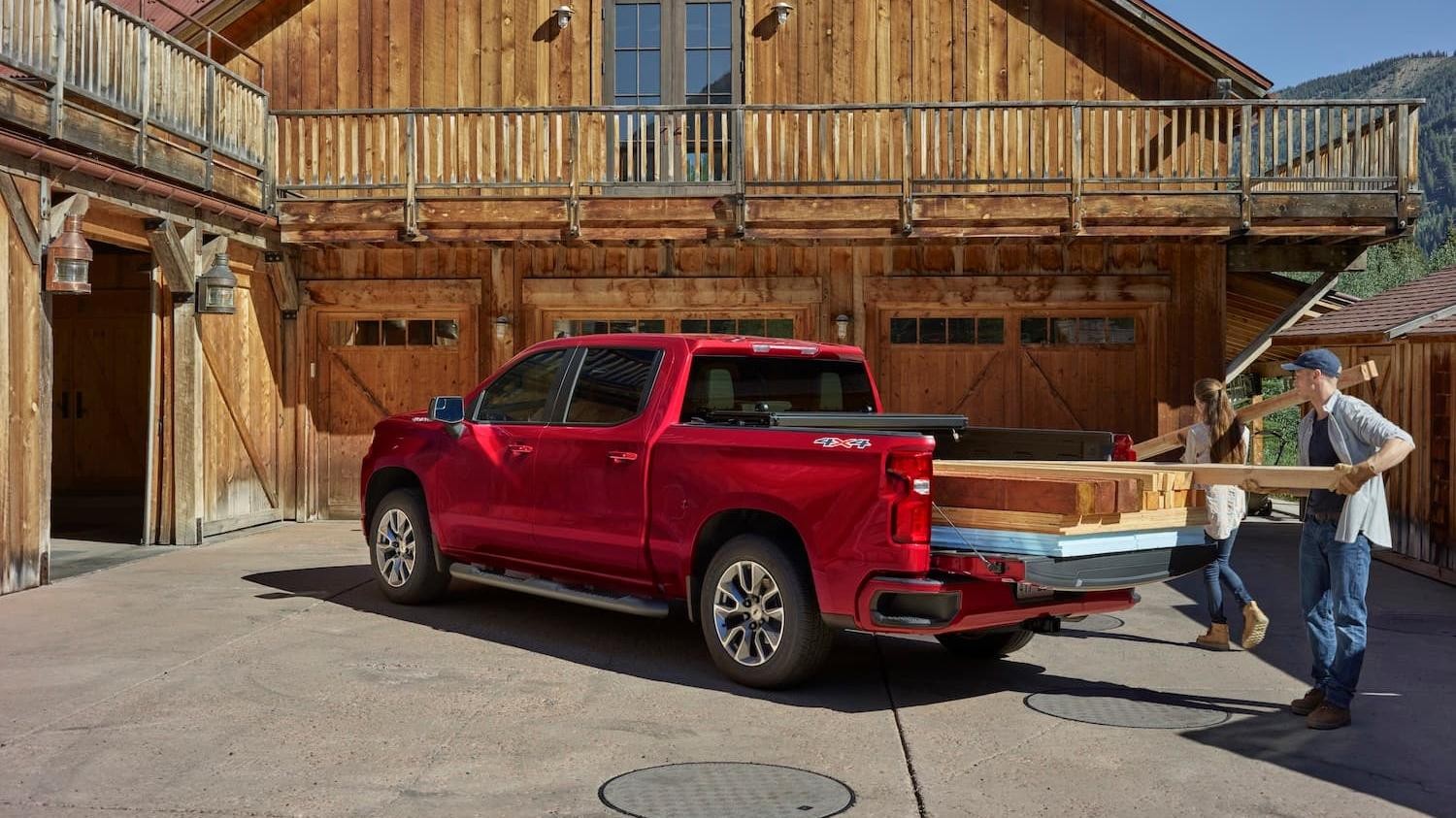 Red Chevy Silverado 1500 Hauling Wood