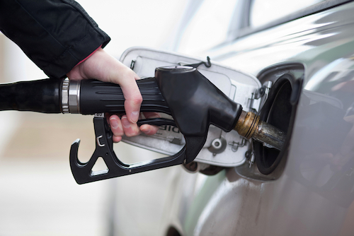 person filling up car with gas