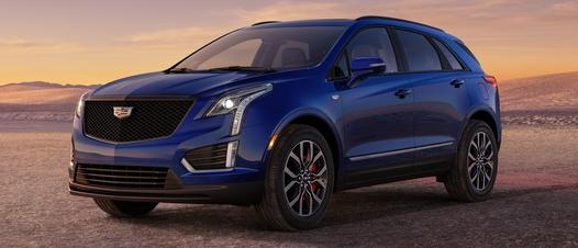 2024 Cadillac XT5 Sport seen in Opulent Blue; interior available in Jet Black; Platinum Package JSE wheels - 3/4 drivers side front view of vehicle on road