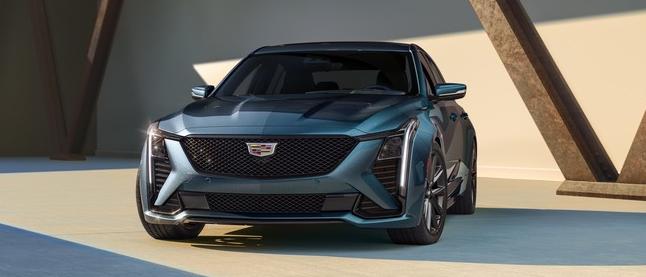 Cadillac 2025 CT5 Sport in Typhoon Metallic (GBW) with Jet Black Leather with Twenty-two Carbon Fiber Trim and 19� Premium+ Paint Finish Alloy Wheels (Q83); LSY 2.0T I4 Engine; 7/8 drivers side front view of vehicle parked;