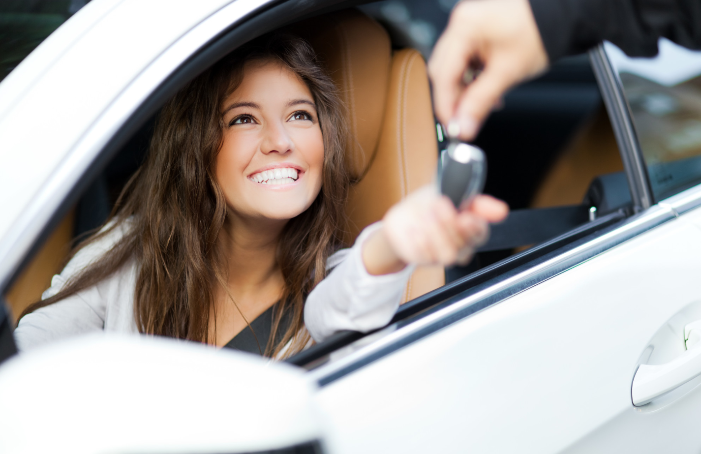 Image of Girl In Car being handed keys