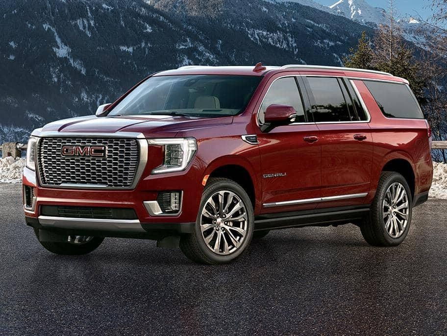 A 2021 GMC  Yukon XL near a snow mountain 