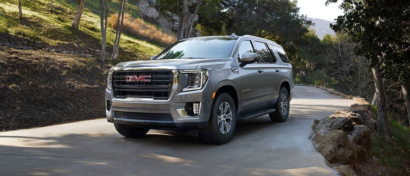 2024 GMC Yukon exterior driving on forest road