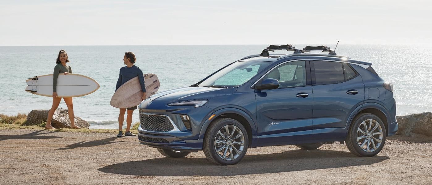 2024 Buick Encore GX exterior at beach with surfers