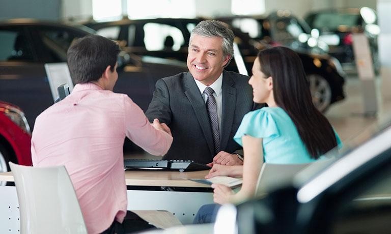 Couple at dealership making deal