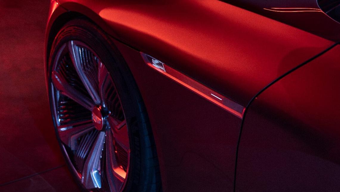 Image of the wheel of a Cadillac vehicle in red light
