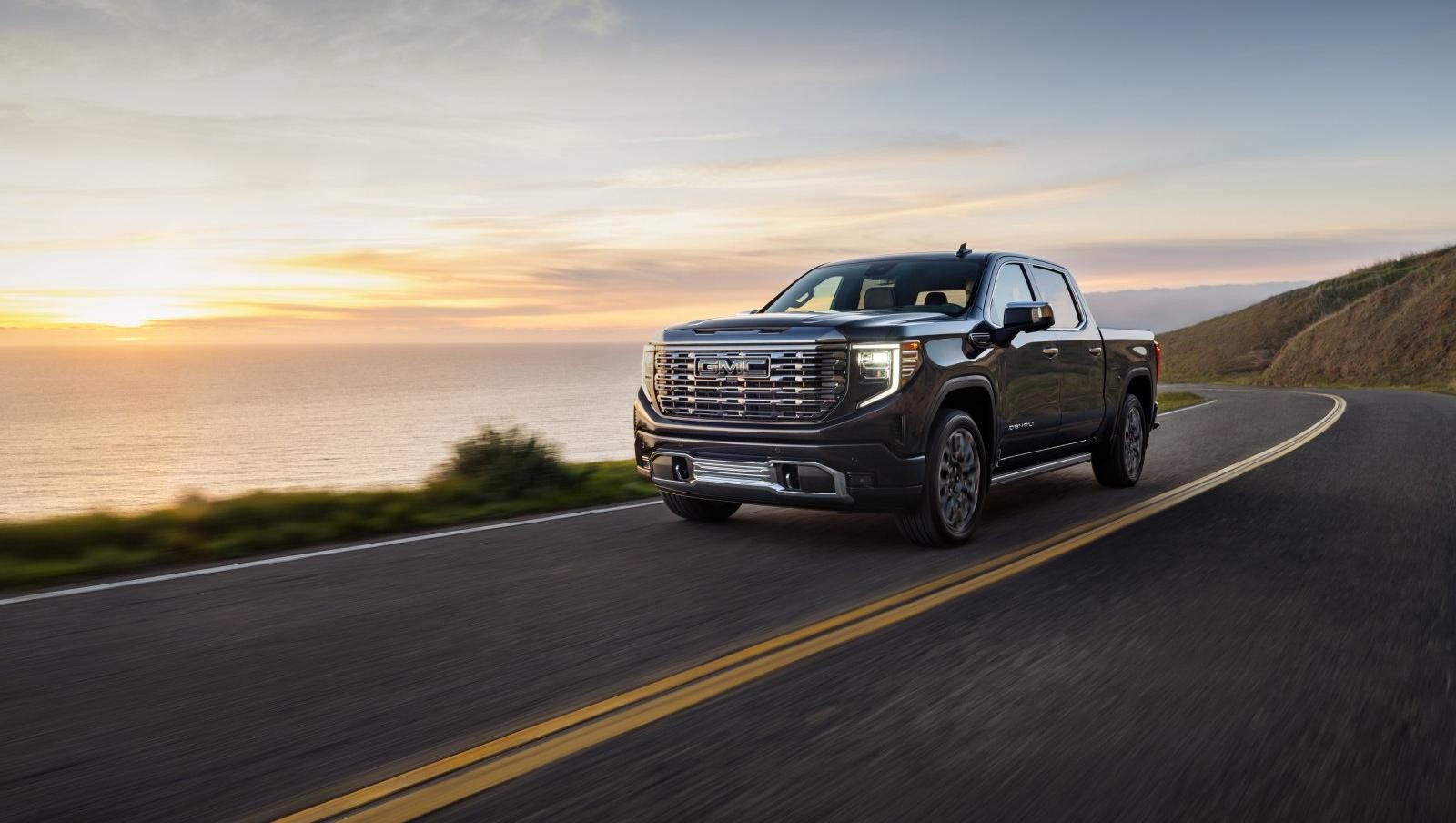 2024 Sierra 1500 Denali driving on a coastal road