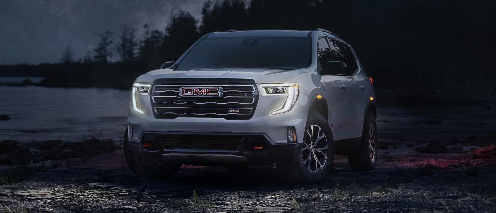 2024 GMC Acadia parked in front of a beach