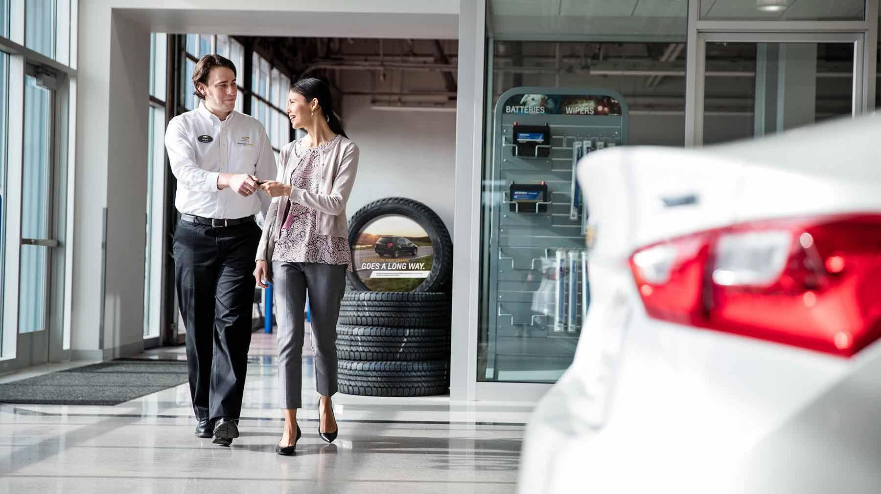 Chevrolet Certified Service Employee handing keys to women.