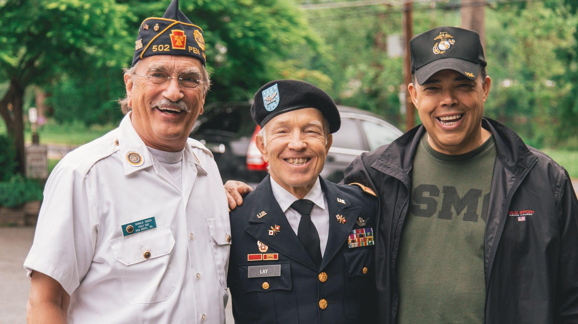 Military Veterans Posing For Camera Smiling