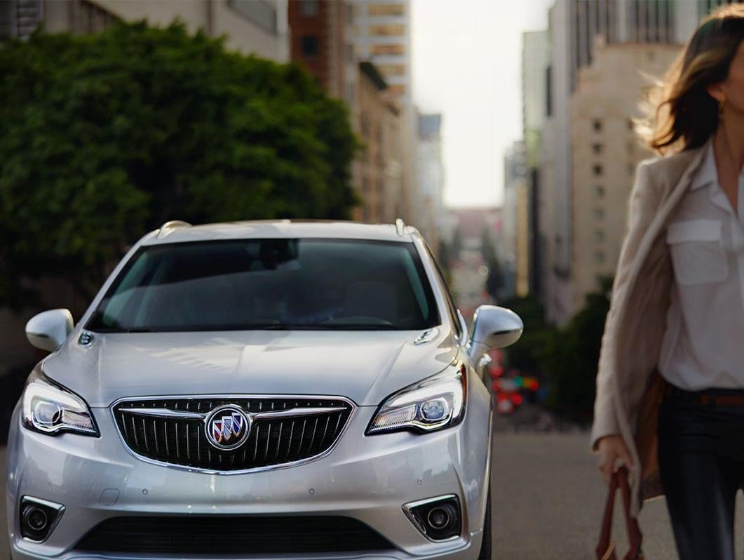 A Buick SUV is parked in an urban area.