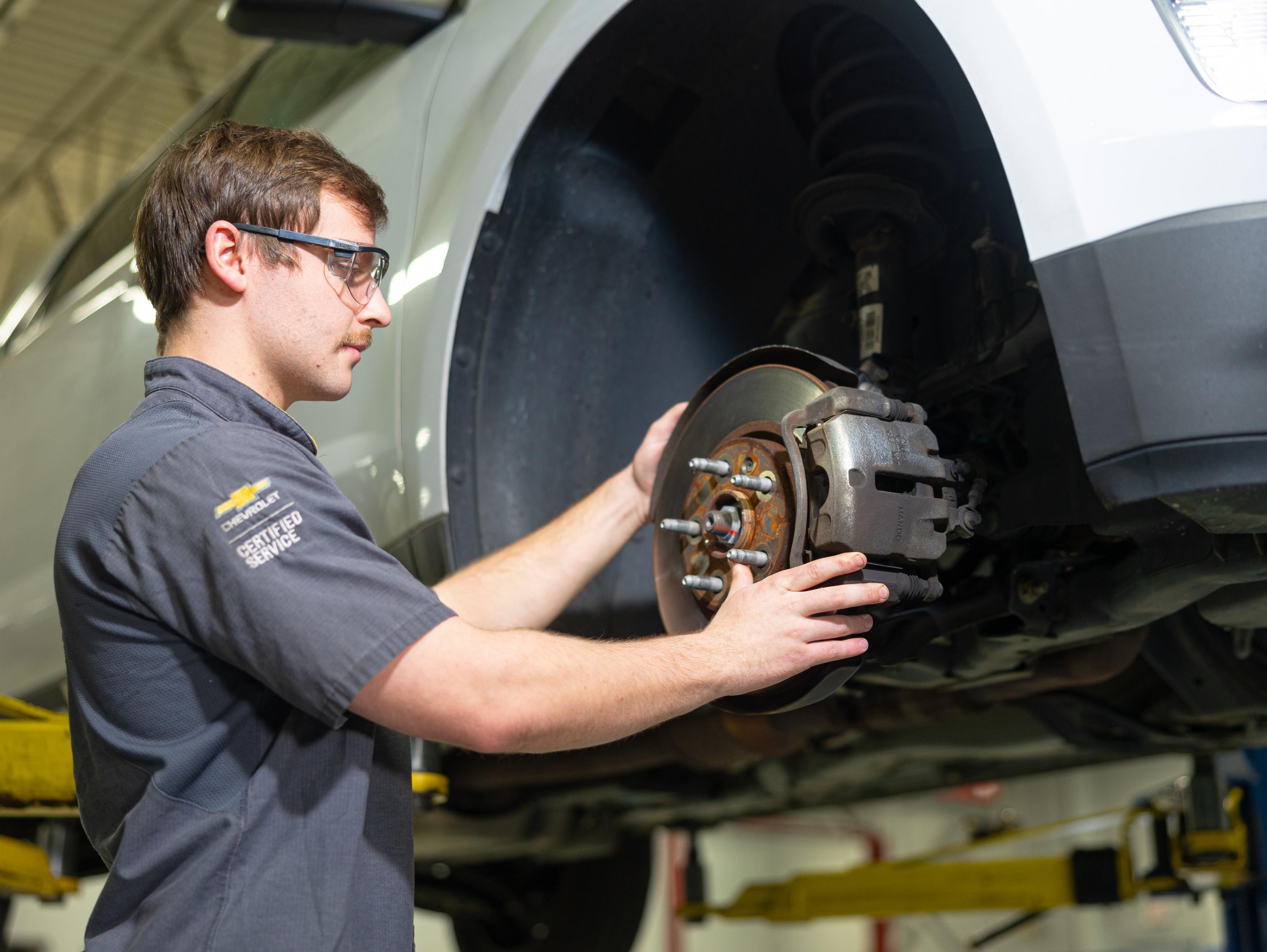 Service technician changing brake pads