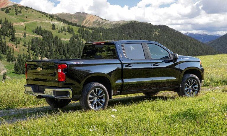 2022 Chevrolet Silverado 1500 exterior in black driving on grassy fields