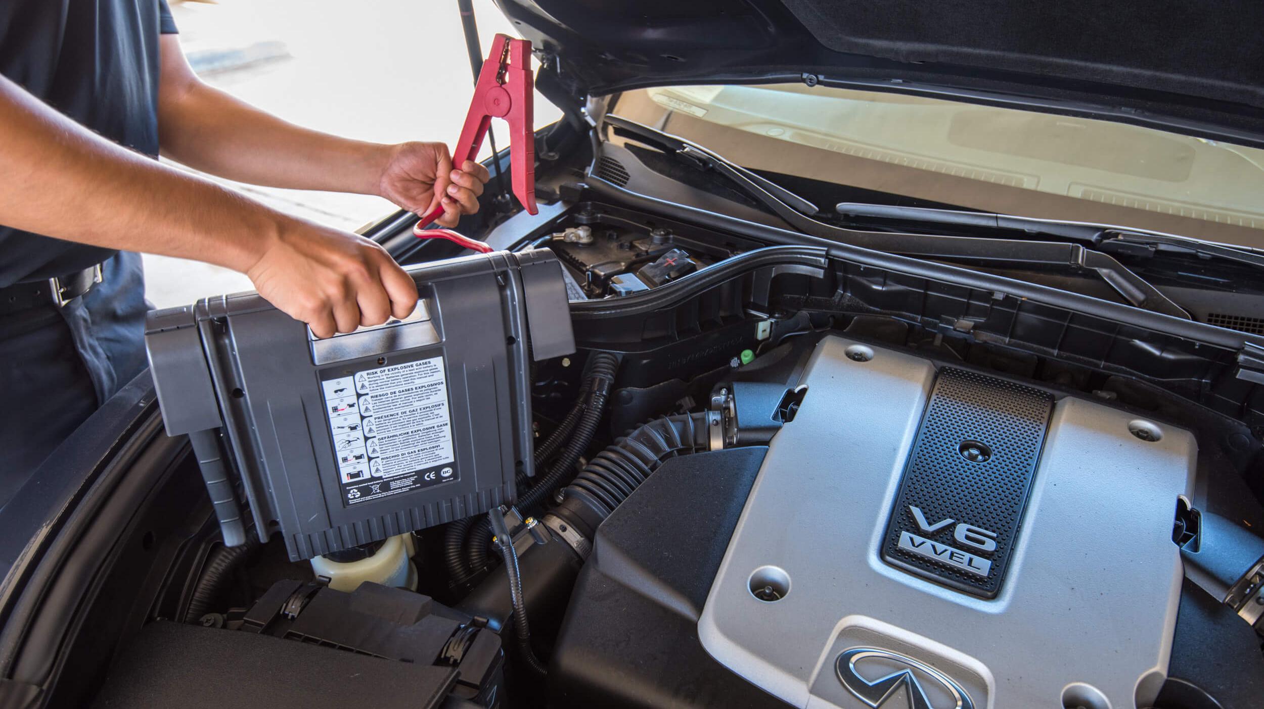 Technician performing service on an INFINITI vehicle
