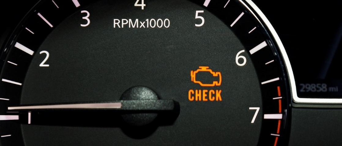 Close up of a tachometer with check engine light on