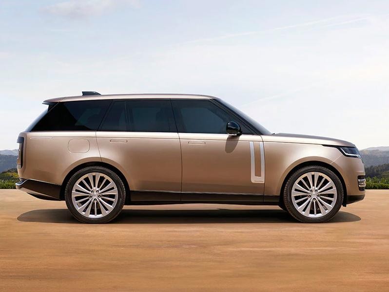 A lantau bronze Range Rover on a country road.