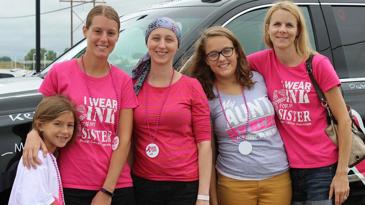 Group of women wearing pink and smiling