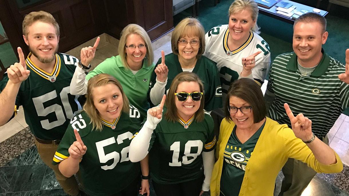Group of people smiling in Green Bay Packer gear