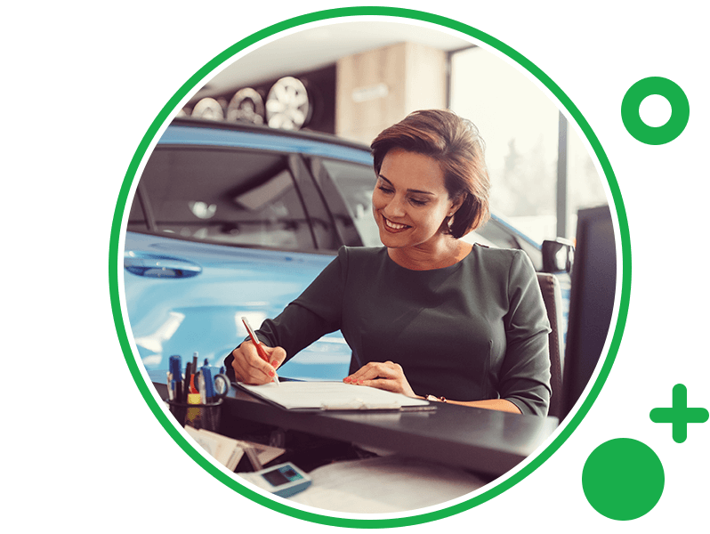 Woman signing documents in dealership