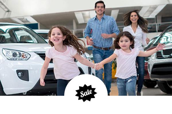 Happy children running in a dealership showroom with sale icon
