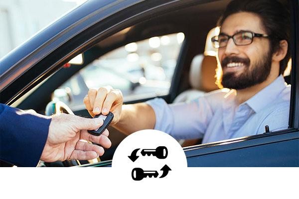 Man taking the keys to his new car with swapping keys icon