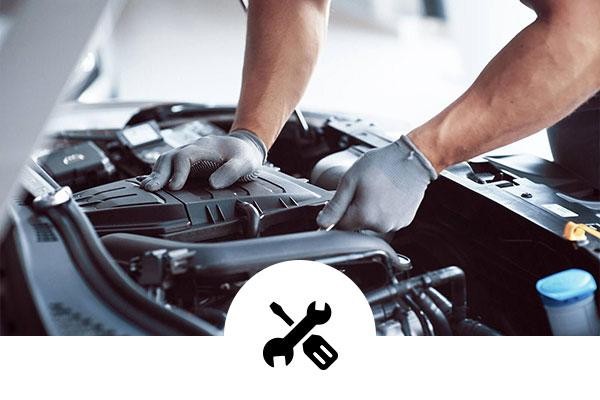 Service technician working on a vehicles with wrench and screwdriver icon