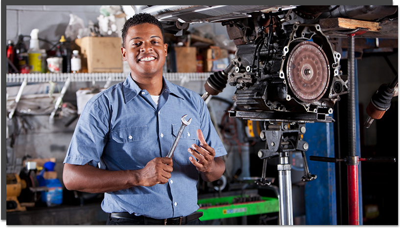 Service staff member holding a wrench and working on an engine