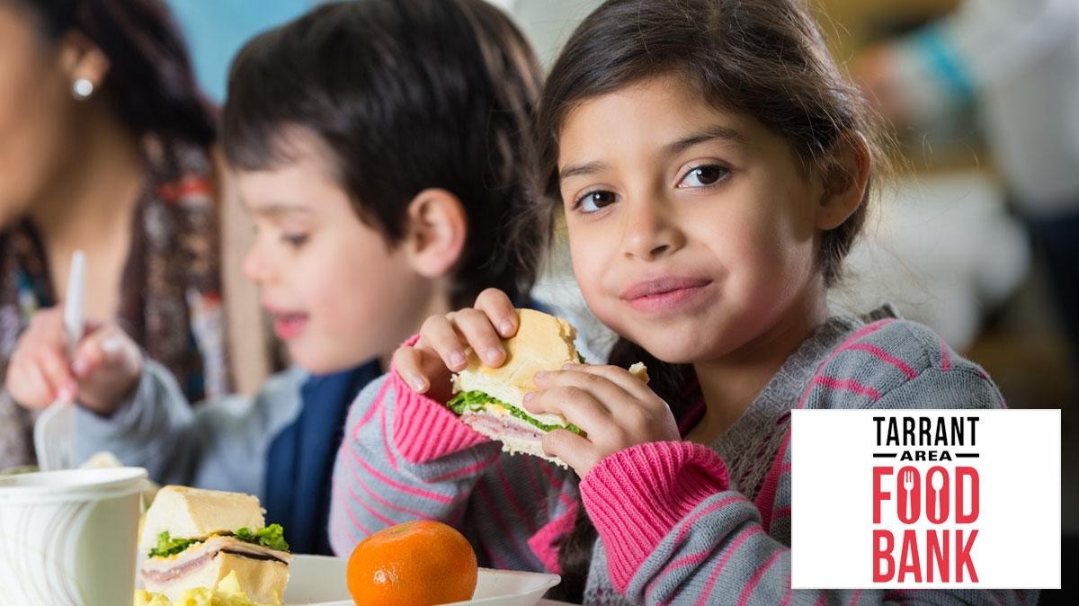 Young girl eating a sandwich Tarrant Area Food Bank